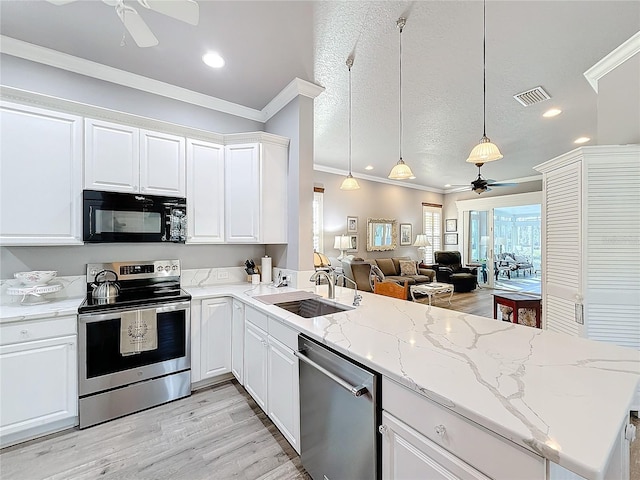 kitchen featuring appliances with stainless steel finishes, kitchen peninsula, sink, and hanging light fixtures