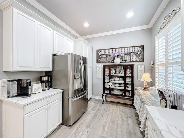 kitchen featuring light hardwood / wood-style flooring, stainless steel refrigerator with ice dispenser, light stone counters, ornamental molding, and white cabinets