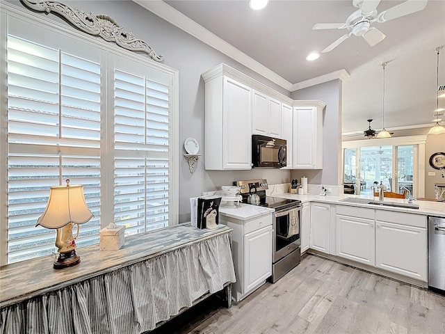 kitchen featuring sink, crown molding, appliances with stainless steel finishes, white cabinets, and light wood-type flooring