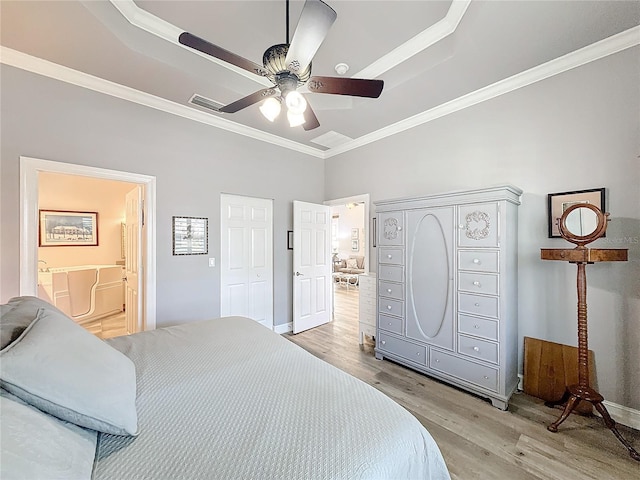 bedroom featuring crown molding, connected bathroom, ceiling fan, and light hardwood / wood-style floors