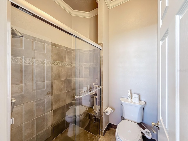 bathroom featuring tile patterned flooring, a shower with shower door, ornamental molding, and toilet