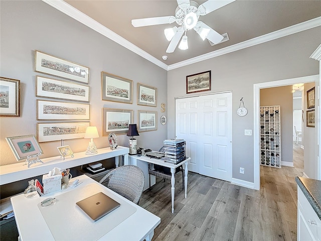 home office featuring crown molding, ceiling fan, and light hardwood / wood-style floors