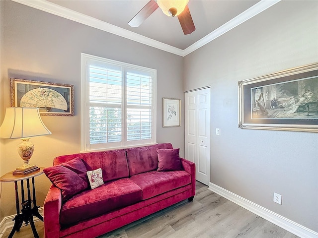 living room with crown molding, ceiling fan, and hardwood / wood-style flooring