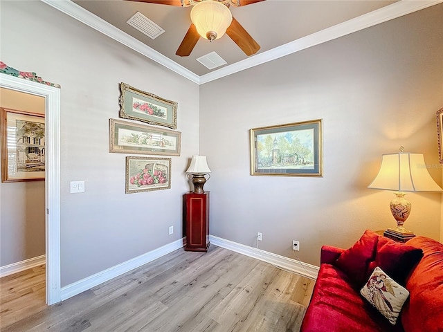 living area featuring ornamental molding, ceiling fan, and light hardwood / wood-style flooring