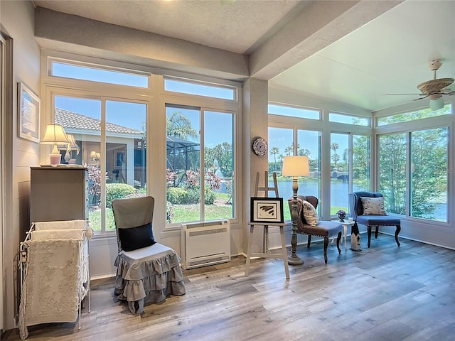 sunroom with plenty of natural light and wood finished floors
