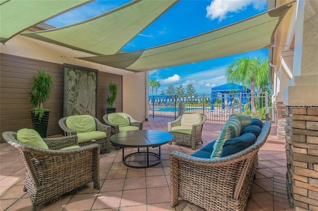 view of patio / terrace featuring fence, a playground, and an outdoor living space