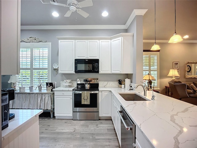 15856 Cobble Mill Dr, Wimauma, FL 33598 - kitchen with stainless steel appliances, crown molding, ceiling fan, light wood-type flooring, and light stone counters