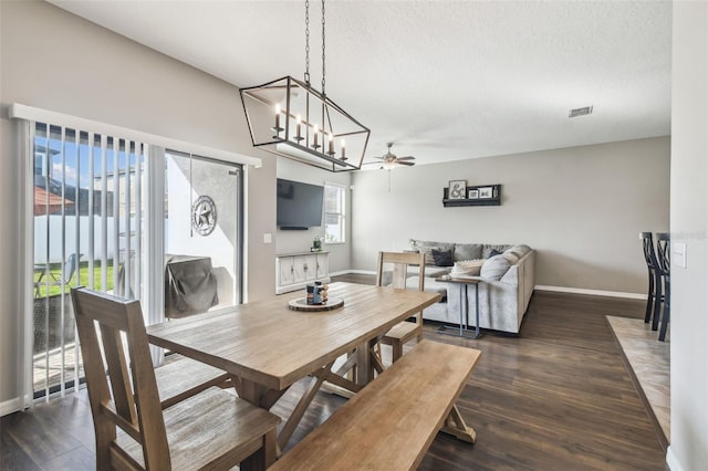 dining area with plenty of natural light, dark hardwood / wood-style floors, and a textured ceiling