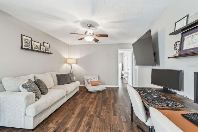 office area with ceiling fan, dark hardwood / wood-style floors, and a textured ceiling