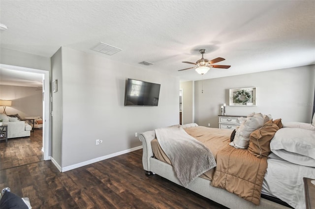 bedroom featuring ceiling fan, dark wood-type flooring, and a textured ceiling