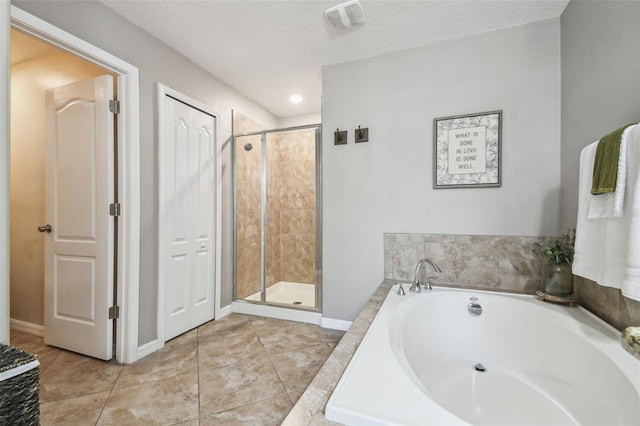 bathroom featuring tile patterned flooring, a textured ceiling, and separate shower and tub