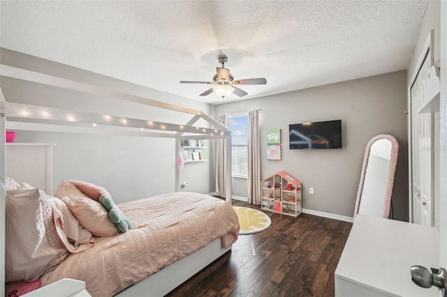 bedroom featuring ceiling fan, dark hardwood / wood-style floors, and a textured ceiling