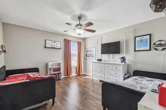 bedroom featuring dark wood-type flooring, ceiling fan, and a textured ceiling