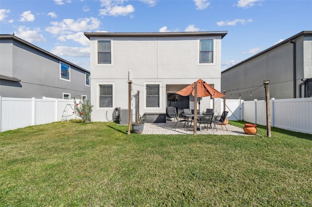 rear view of property with a yard, central AC unit, and a patio