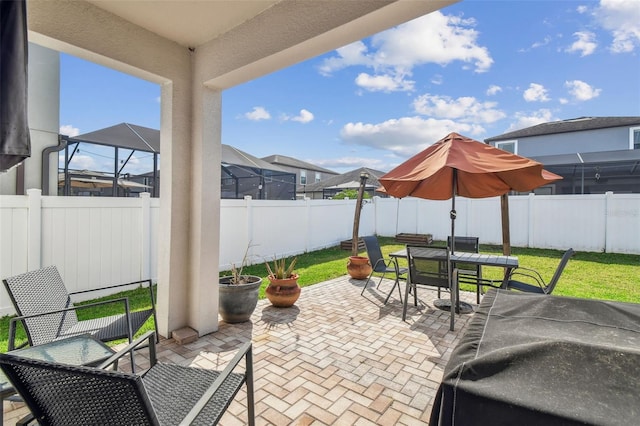 view of patio with glass enclosure