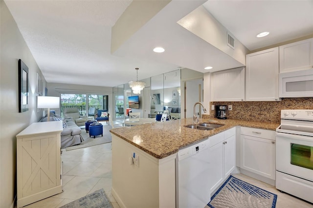 kitchen featuring sink, white appliances, kitchen peninsula, and white cabinets