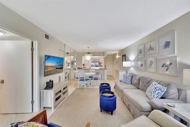 living room with light tile patterned flooring and a textured ceiling