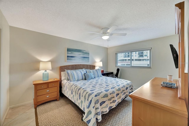 bedroom with light tile patterned floors, a textured ceiling, and ceiling fan