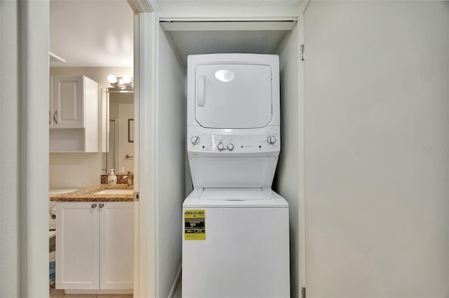 laundry room with stacked washer and dryer and sink