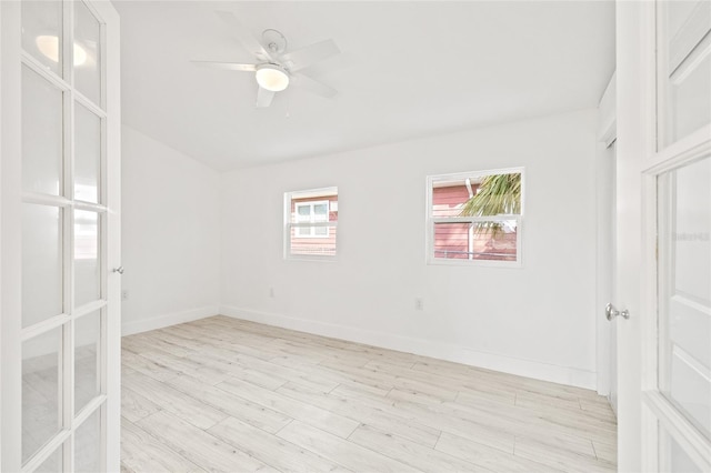 empty room featuring ceiling fan, light hardwood / wood-style floors, and french doors