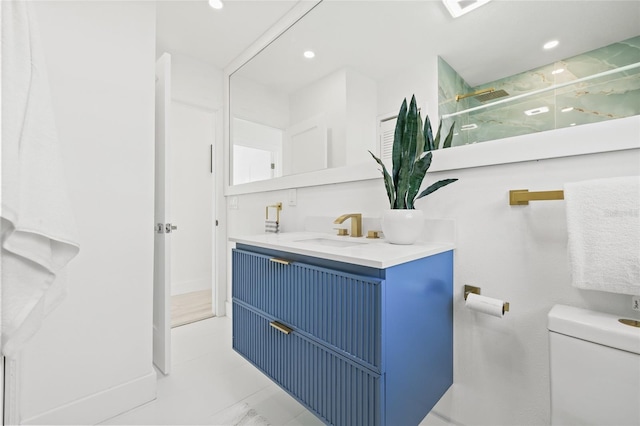 bathroom featuring vanity, toilet, and walk in shower