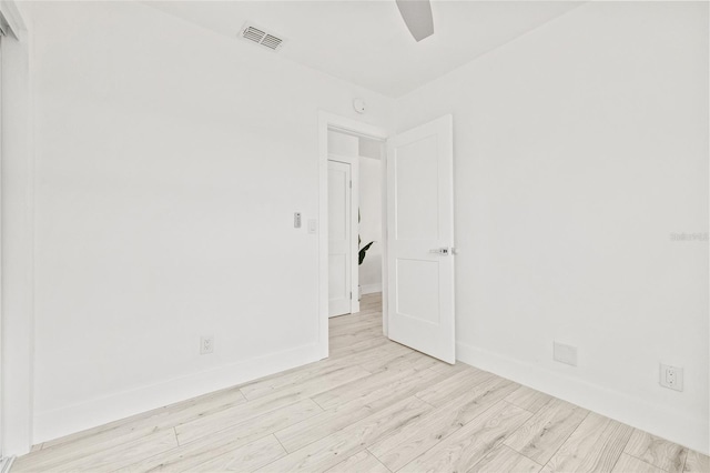 spare room with ceiling fan and light wood-type flooring