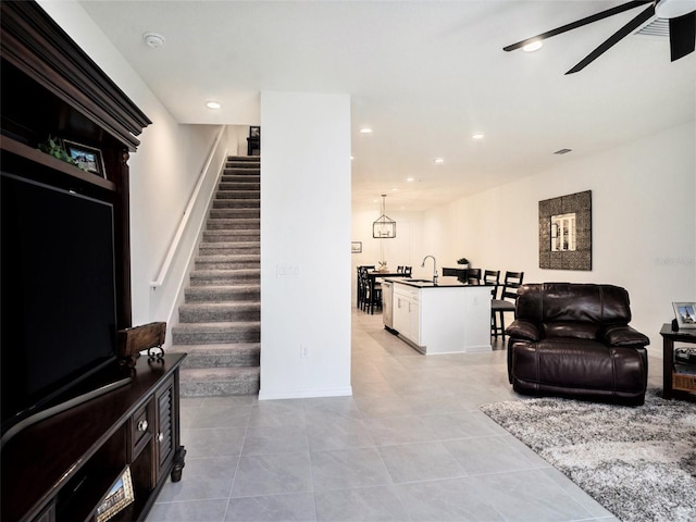 living room with light tile patterned floors, stairs, a ceiling fan, and recessed lighting