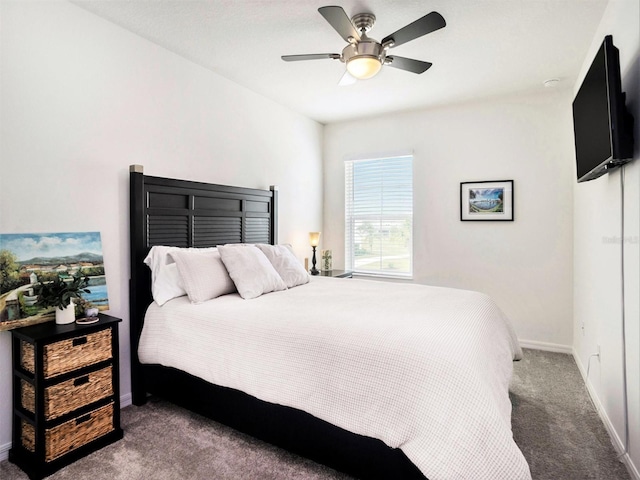 carpeted bedroom with ceiling fan and baseboards