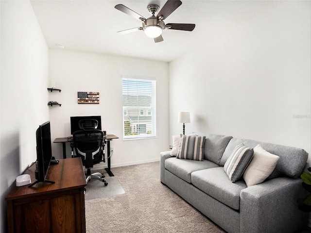 carpeted office with ceiling fan and baseboards