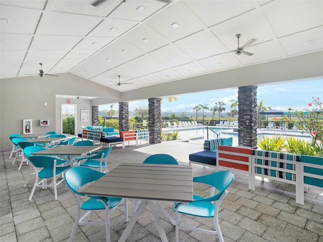 view of patio / terrace featuring ceiling fan, outdoor dining area, and a community pool