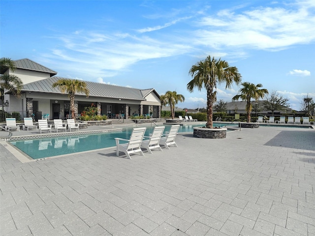 pool featuring a patio area and fence