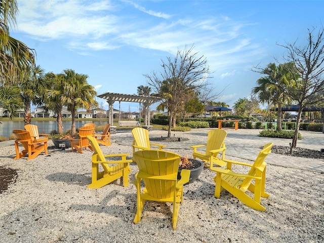 view of community featuring an outdoor fire pit and a pergola