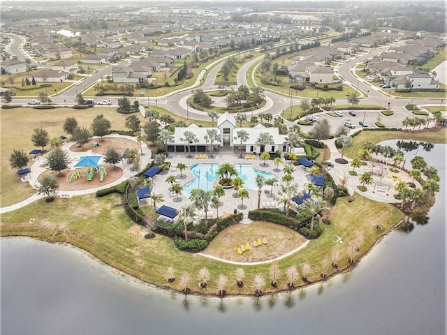 birds eye view of property with a water view and a residential view