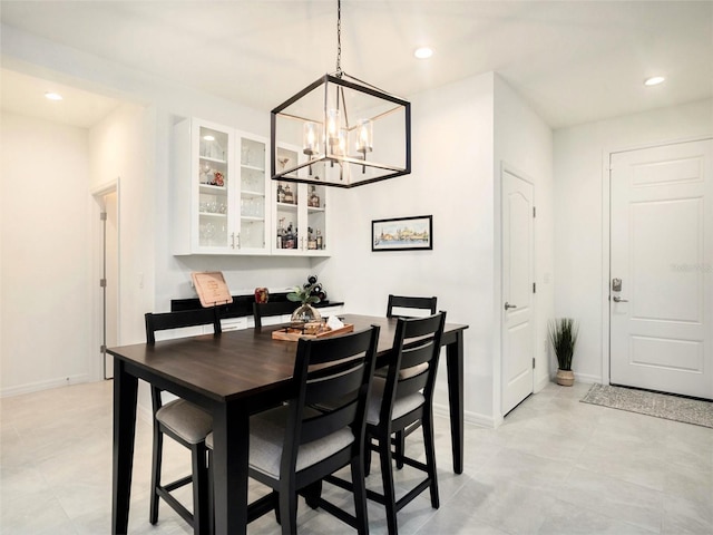 dining space featuring baseboards, a chandelier, and recessed lighting