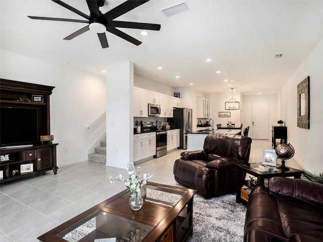 living area featuring stairway, recessed lighting, visible vents, and light tile patterned flooring