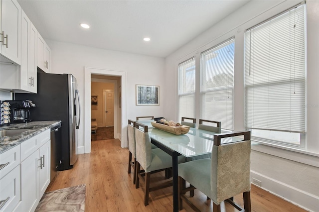 dining area with light hardwood / wood-style floors