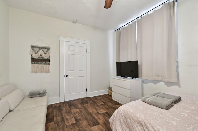 bedroom with dark wood-type flooring and ceiling fan