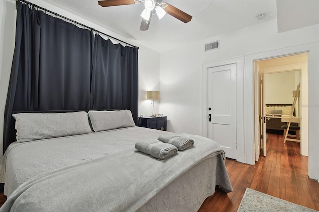 bedroom with dark hardwood / wood-style floors and ceiling fan