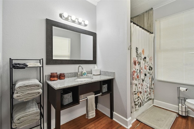 bathroom with vanity, hardwood / wood-style floors, and shower / bath combo with shower curtain