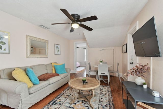 living room with dark wood-type flooring and ceiling fan