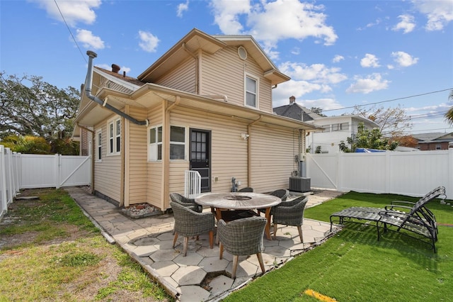 rear view of property featuring a yard and a patio