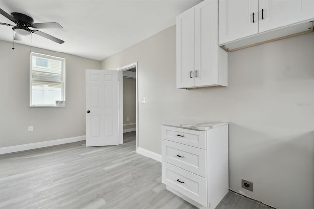 interior space with white cabinetry, ceiling fan, and light hardwood / wood-style flooring