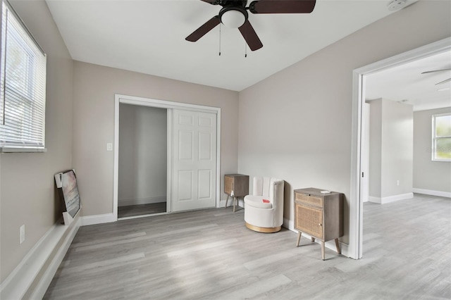 interior space featuring a closet, heating unit, ceiling fan, and light hardwood / wood-style flooring