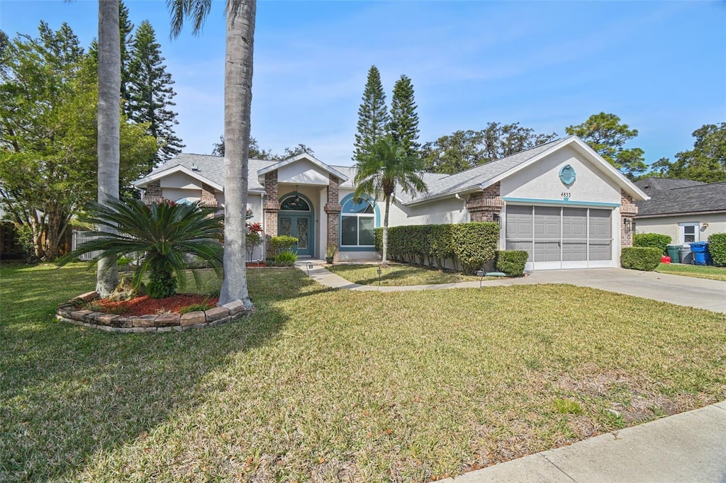 ranch-style home with a garage and a front yard