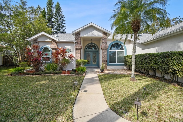 view of front of property with a front yard and french doors