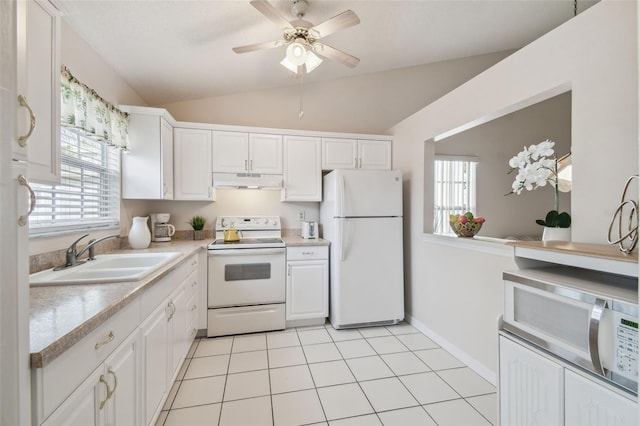 kitchen featuring white cabinetry, lofted ceiling, sink, light tile patterned floors, and white appliances