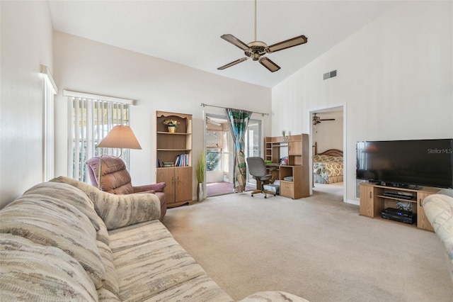 carpeted living room featuring ceiling fan, high vaulted ceiling, and a wealth of natural light