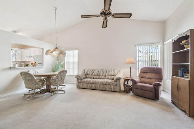 carpeted living room featuring high vaulted ceiling and ceiling fan