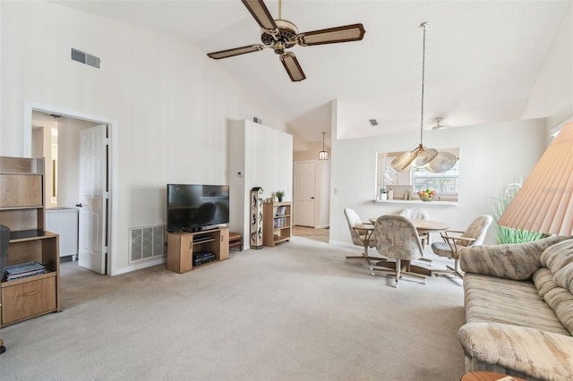 living room featuring ceiling fan, high vaulted ceiling, and light carpet