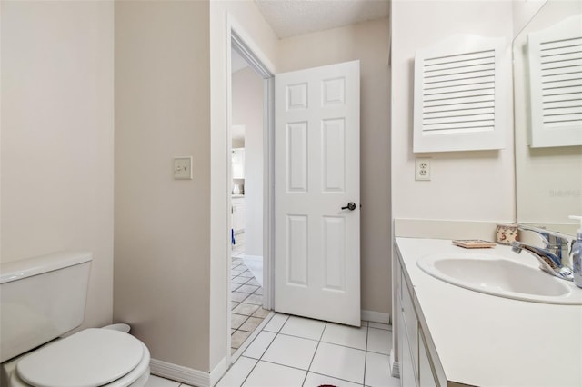 bathroom with vanity, tile patterned flooring, a textured ceiling, and toilet